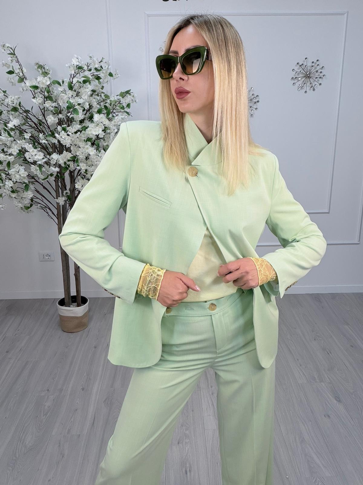 Giacca Maryley Verde Menta indossata da donna con occhiali da sole, in un ambiente elegante.
